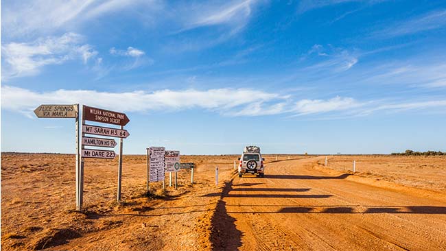 Australien, Wegweiser in der Wüste, Jeep auf Schotterpiste